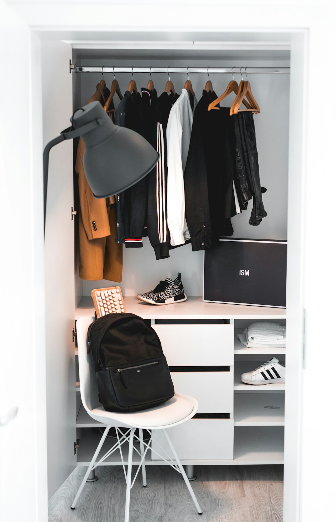 Black Backpack On White Chair Beside Cabinet Photo Free Chair Image On Unsplash