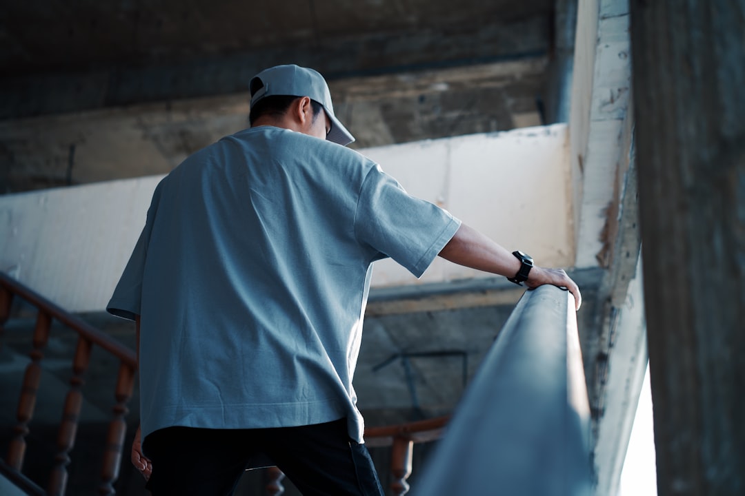man holding handrail photo free banister image on unsplash