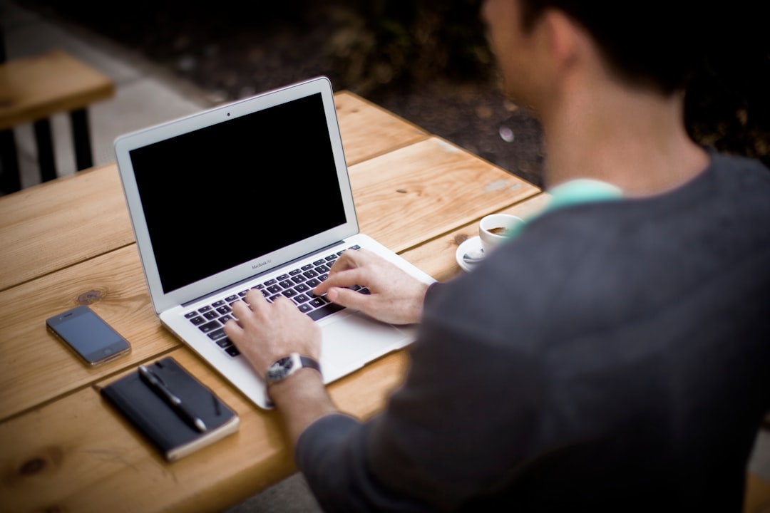 man in front of laptop computer in shallow focus photography, Working on a laptop outdoors