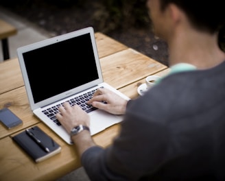 man in front of laptop computer in shallow focus photography