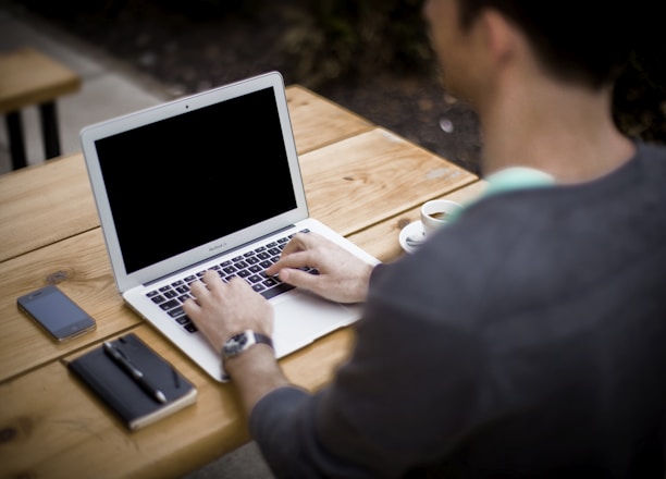 man in front of laptop computer in shallow focus photography