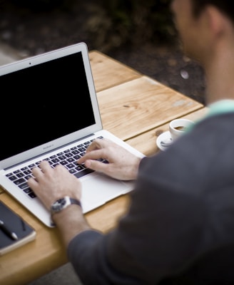man in front of laptop computer in shallow focus photography