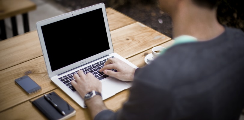 man in front of laptop computer in shallow focus photography