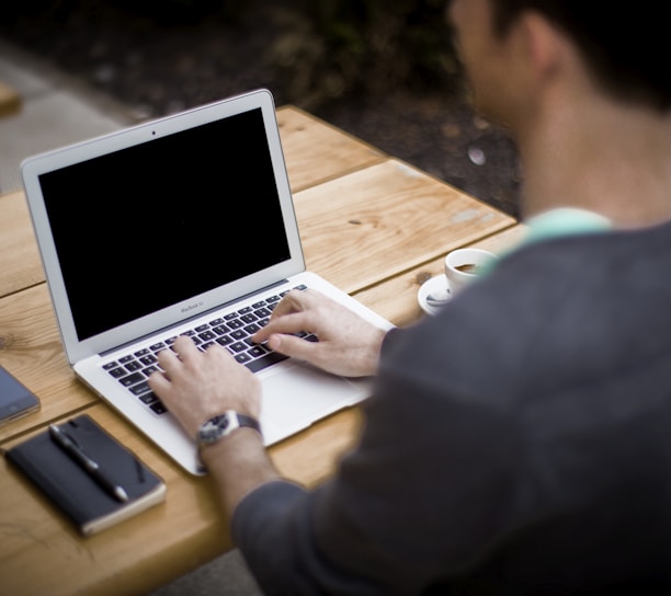 man in front of laptop computer in shallow focus photography