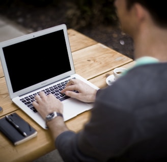 man in front of laptop computer in shallow focus photography