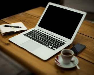 MacBook Air on brown wooden table
