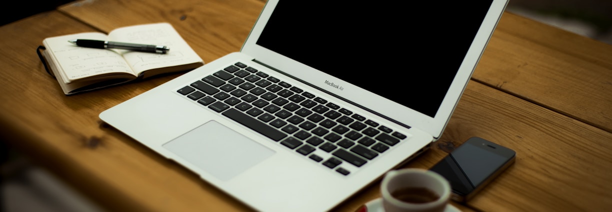 MacBook Air on brown wooden table