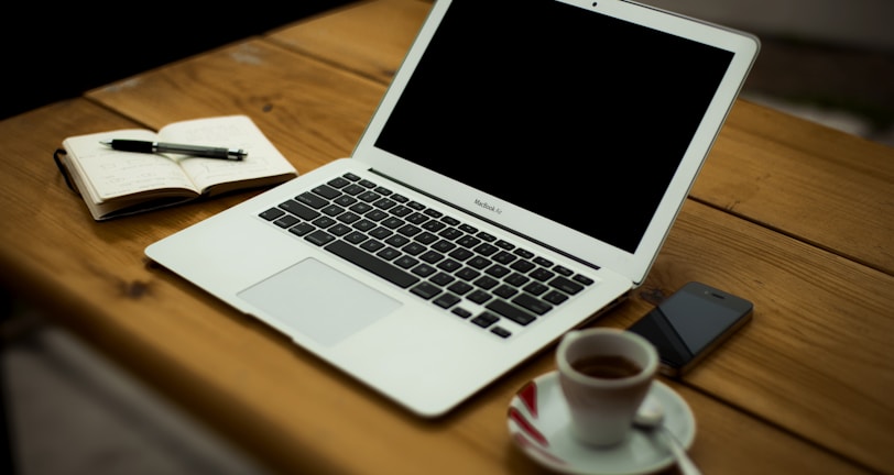 MacBook Air on brown wooden table