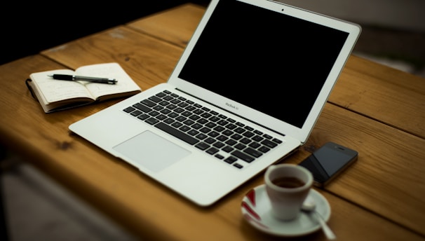 MacBook Air on brown wooden table