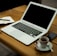 MacBook Air on brown wooden table