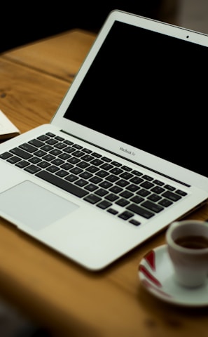 MacBook Air on brown wooden table