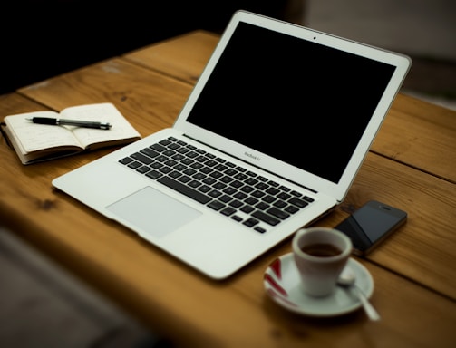 MacBook Air on brown wooden table