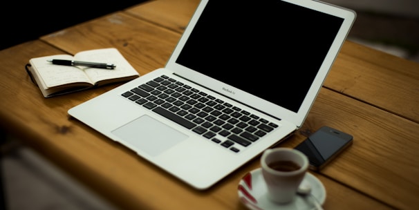 MacBook Air on brown wooden table