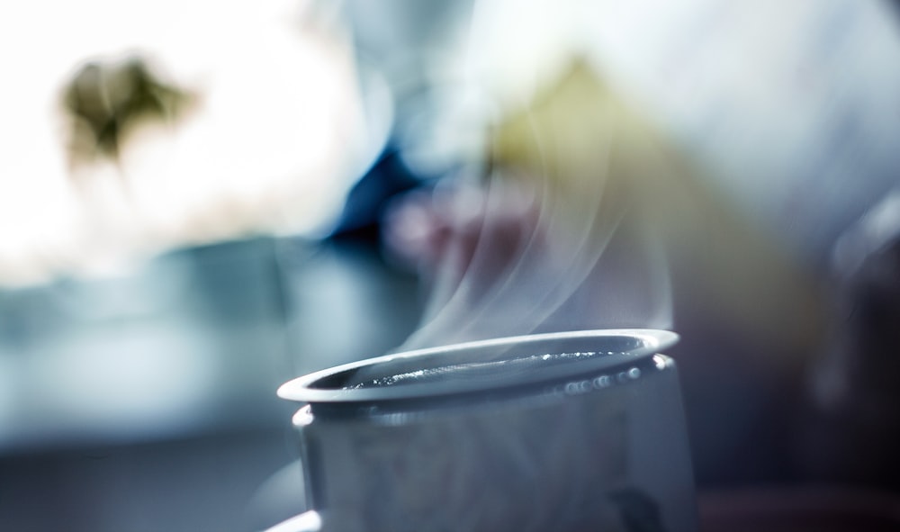 close-up photography of gray metal container with smoke