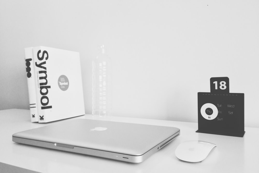 silver MacBook and black JBL