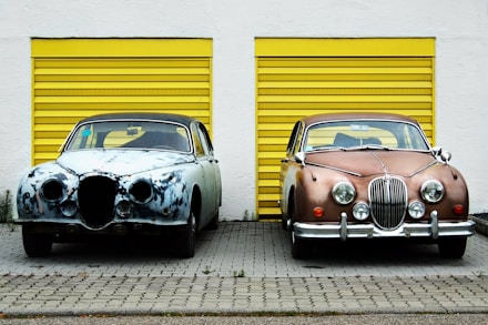 two cars in front of shutter doors