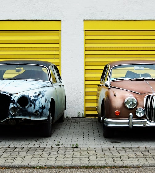 two cars in front of shutter doors