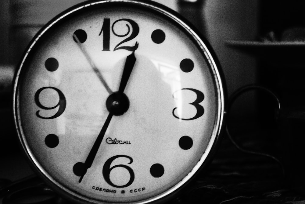 grayscale photo of analog clock