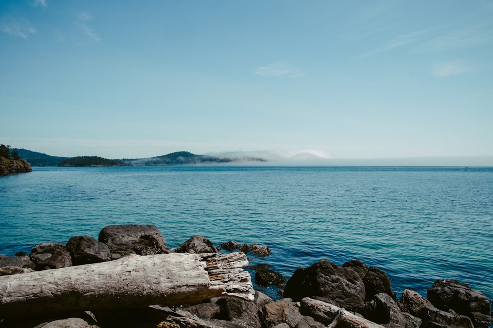 body of water under blue sky