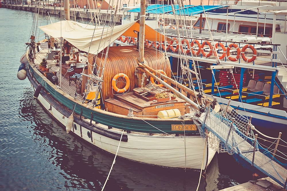 white and brown boat by the dock