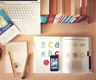 pencils and smartphone on top of books