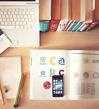 pencils and smartphone on top of books
