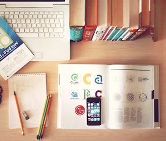 pencils and smartphone on top of books