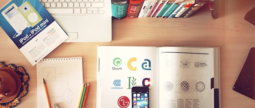 pencils and smartphone on top of books