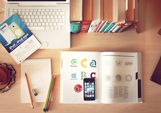 pencils and smartphone on top of books