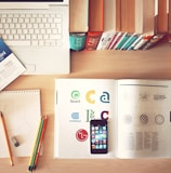 pencils and smartphone on top of books