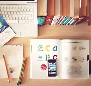 pencils and smartphone on top of books