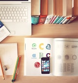 pencils and smartphone on top of books