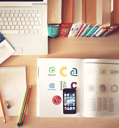 pencils and smartphone on top of books