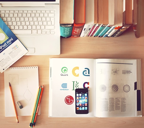 pencils and smartphone on top of books