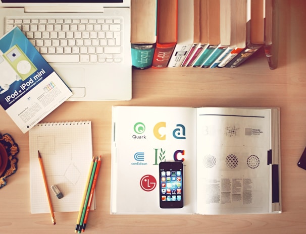 pencils and smartphone on top of books