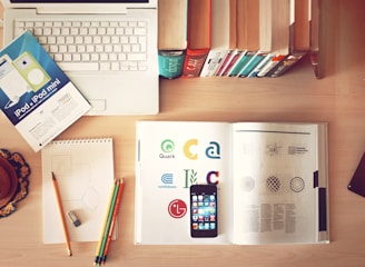 pencils and smartphone on top of books