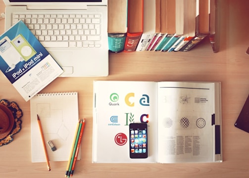 pencils and smartphone on top of books