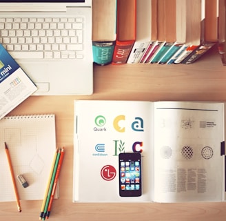 pencils and smartphone on top of books