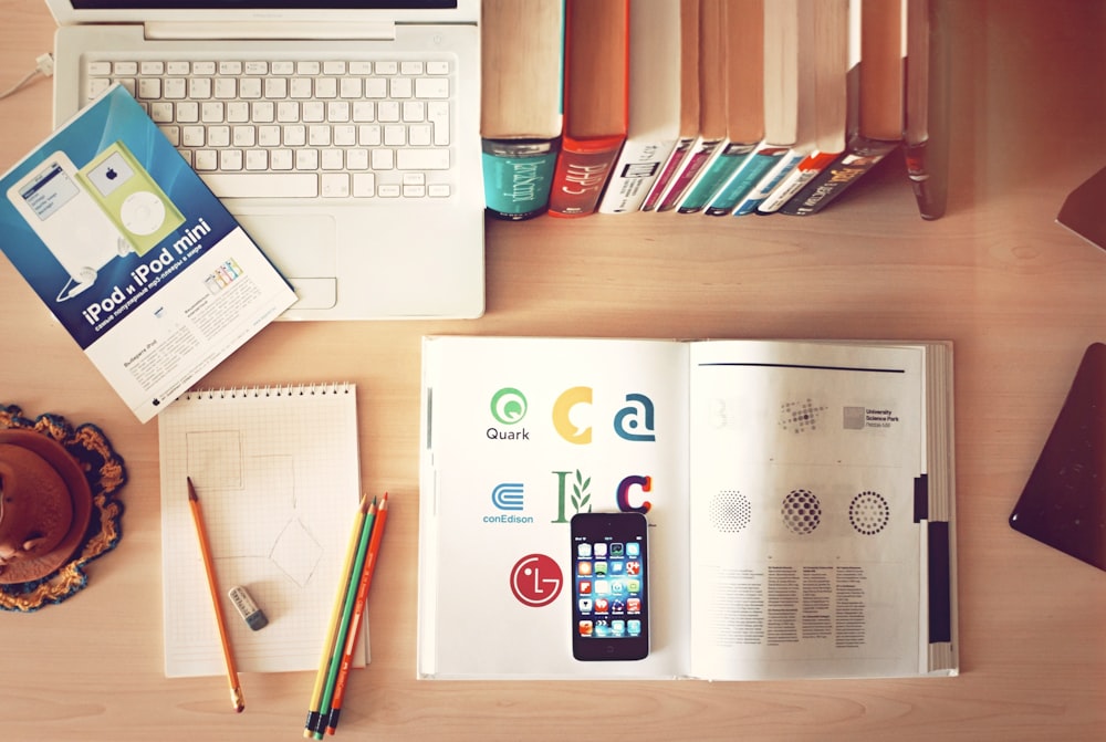 pencils and smartphone on top of books