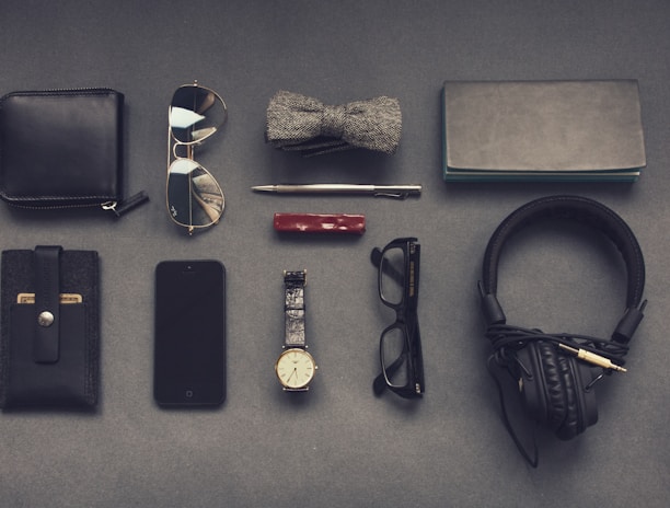 black corded headphones near eyeglasses