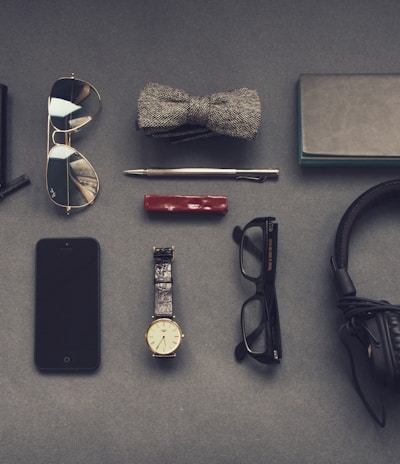 black corded headphones near eyeglasses