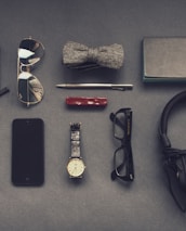 black corded headphones near eyeglasses