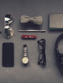 black corded headphones near eyeglasses
