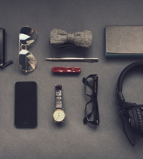 black corded headphones near eyeglasses