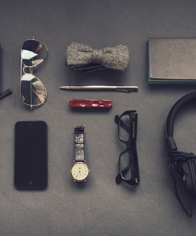 black corded headphones near eyeglasses