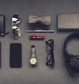 black corded headphones near eyeglasses