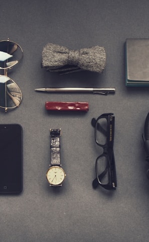 black corded headphones near eyeglasses