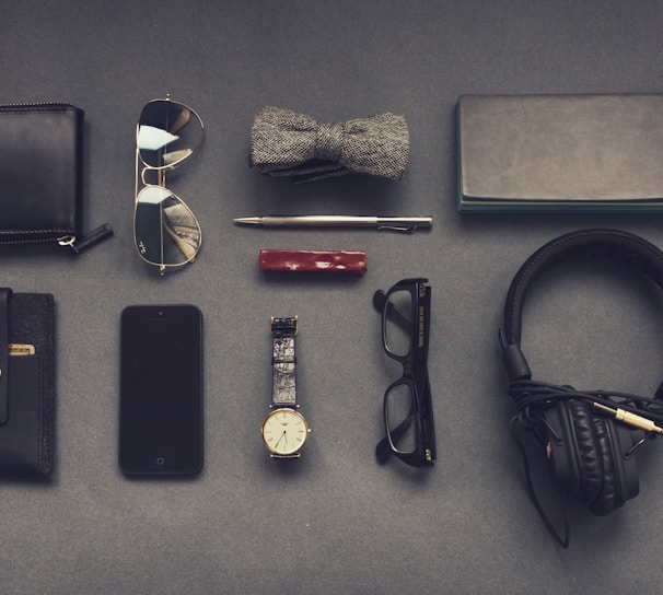 black corded headphones near eyeglasses