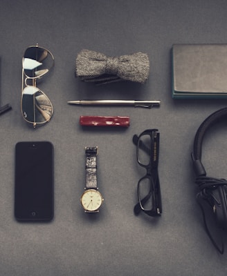 black corded headphones near eyeglasses