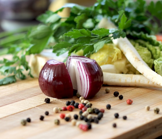 red onion on brown wooden chopping board